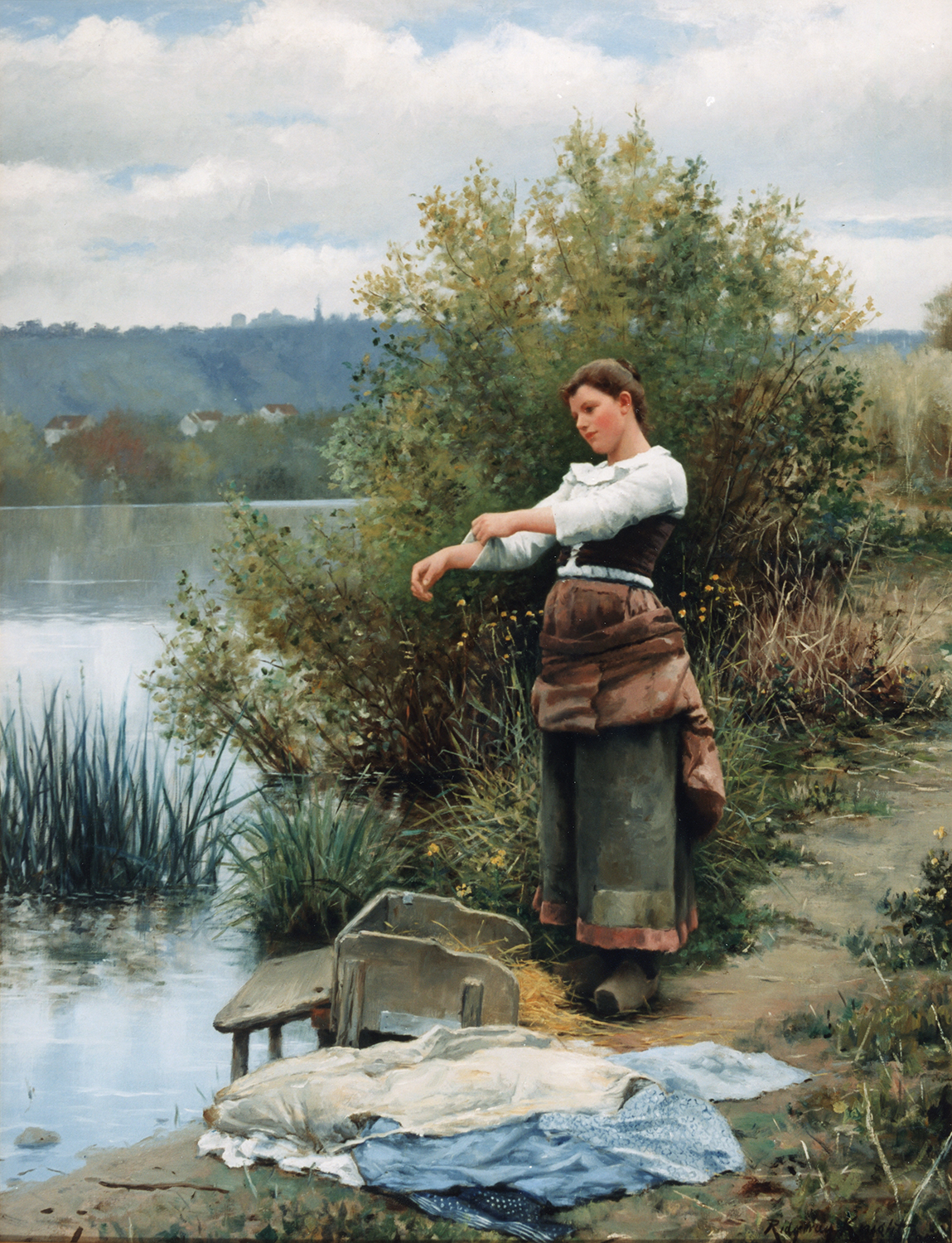 Woman getting ready to wash clothes in a river