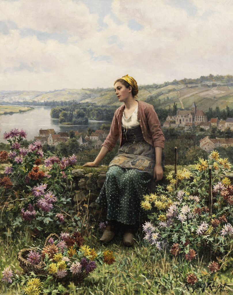 Woman seated on a wall with flowers and the town of Vetheuil in the background